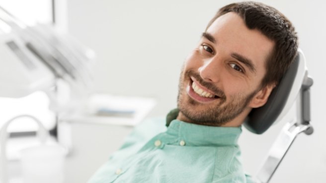 Smiling man leaning back in dental chair