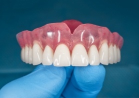 Dentist holding upper denture