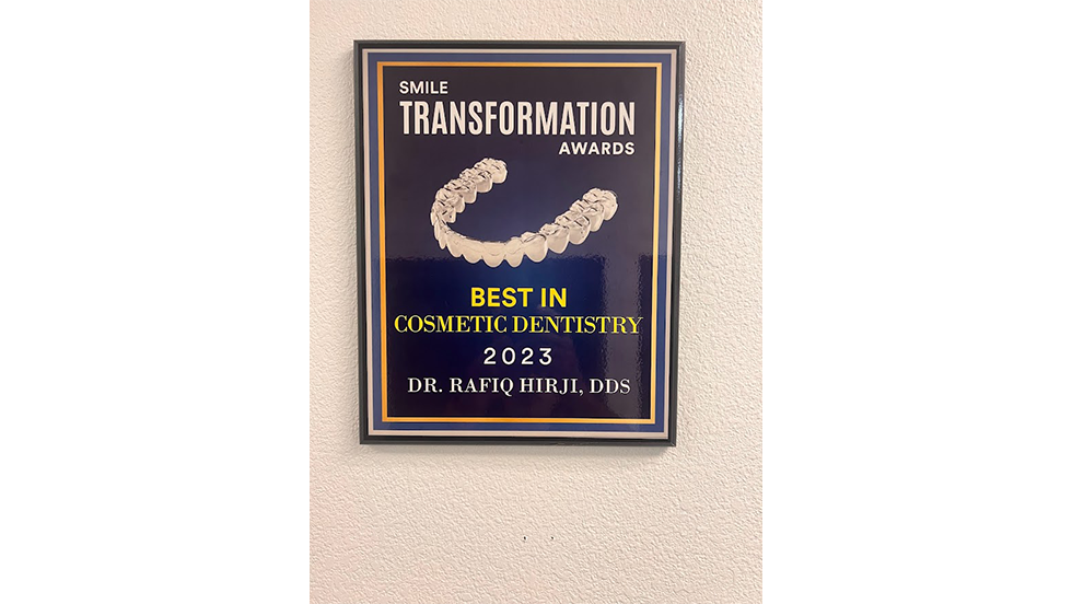 Plaque on wall reading Smile Transformation Awards Best in Cosmetic Dentistry 2023 Rafiq Hirji D D S