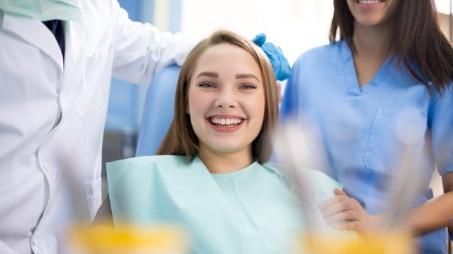 Young woman grinning in dental chair