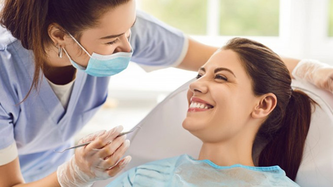 a dental hygienist speaking to a patient