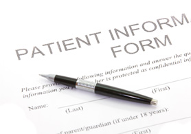 empty new patient forms with a pen on top of them
