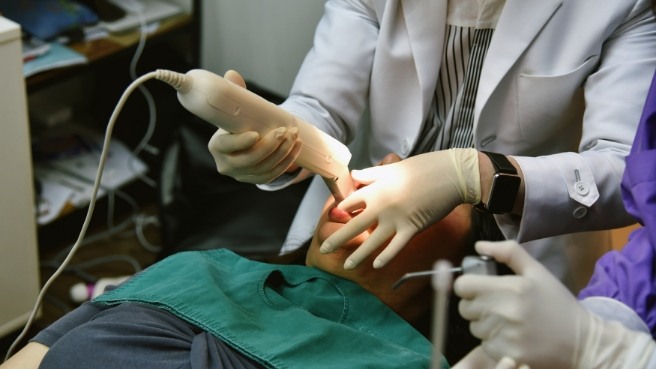 Dentist taking digital impressions of a dental patient
