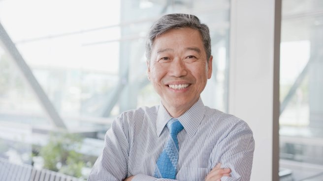 Smiling man in collared shirt and tie