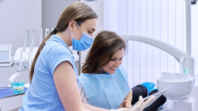a dentist speaking with a patient about dental implants