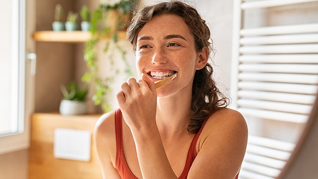 a woman brushing her teeth