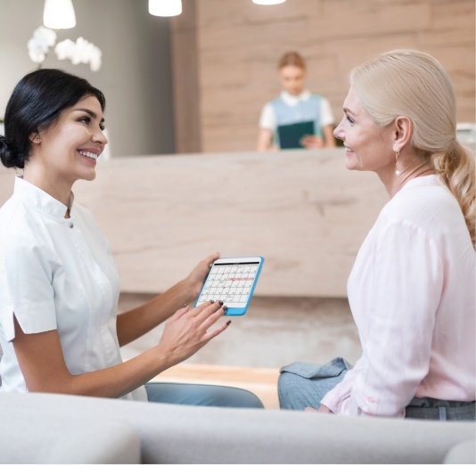 receptionist going over options with patient