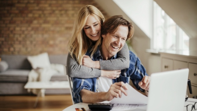 Man and woman looking on laptop at dentist reviews in Irving