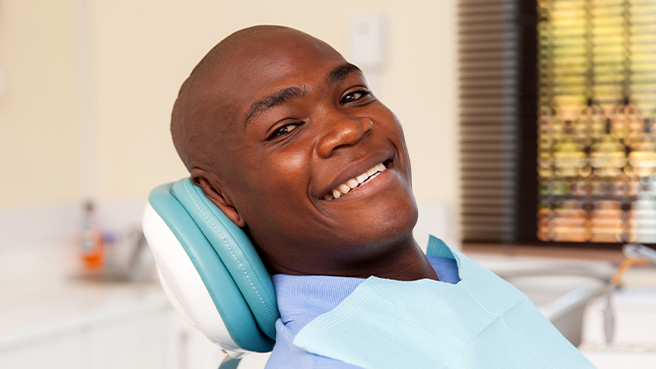 Smiling man leaning back in dental chair