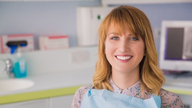 Blonde woman smiling in dental chair