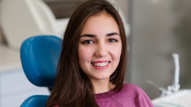 Teen girl in dental chair with braces