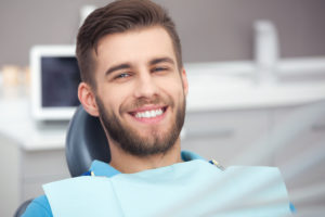 man smiling in the dental chair