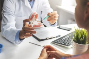 dentist in Irving speaking to a patient about the health of their mouth