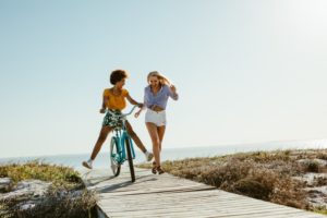 friends playing on the beach together and enjoying the summer