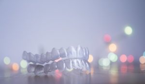 Invisalign in Irving and Christmas lights in background 