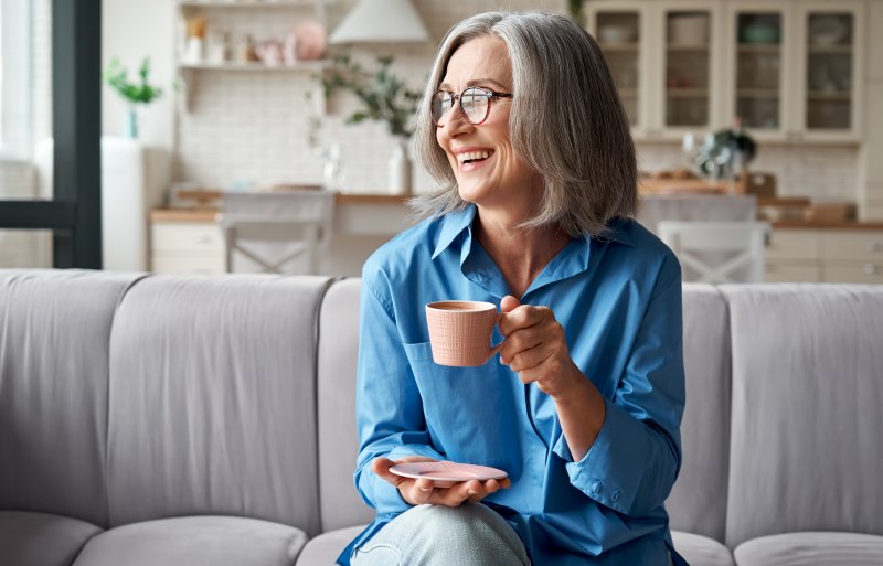 mature woman smiling with dental implants in Irving