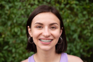 young adult with braces on smiling