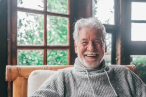 a smiling person sitting in a chair