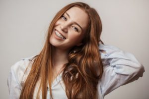 a person with braces, smiling