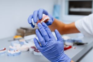 a dental lab technician crafting dentures