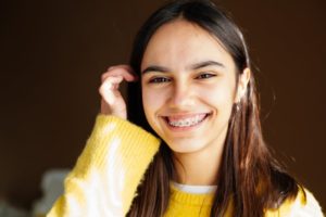 a person with braces smiling