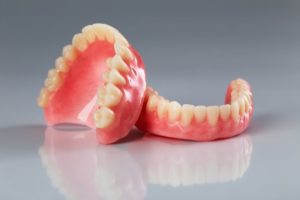 two dentures sitting on a gray countertop