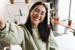 a smiling woman taking a selfie