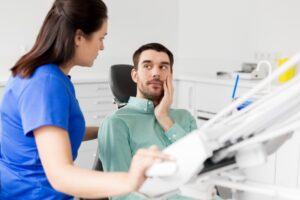 a patient speaking with their dentist in Irving