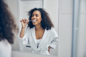 a woman brushing her teeth