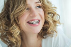 a woman with braces smiling