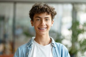 a young teen smiling with braces