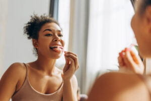 a woman cleaning her tongue