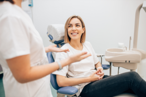 a dental hygienist speaking with a patient