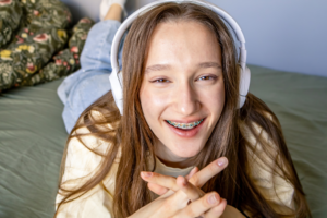 a teenager smiling with headphones on
